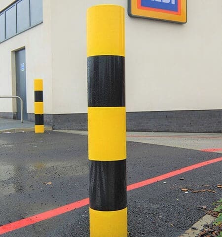 Protection banded security bollard with high-visibility bands, ensuring robust perimeter defense.